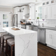 Kitchen with waterfall granite countertops whose stone takes a right angle and extends all the way to the floor